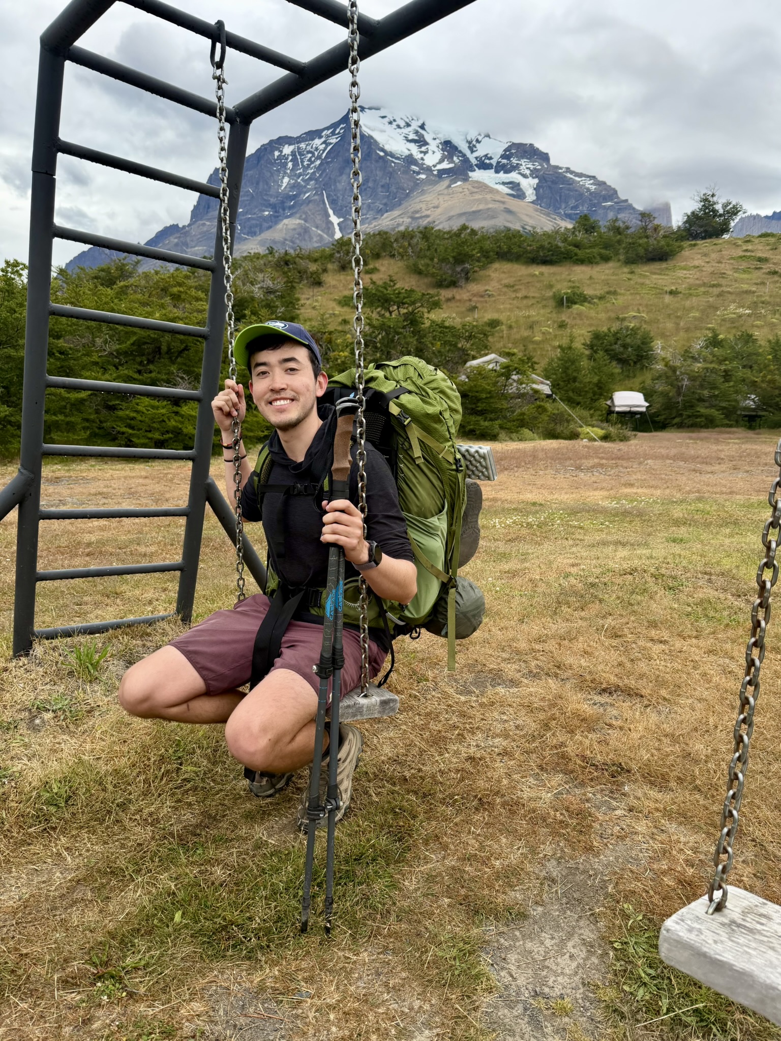 Harvey Delaney on a swing in Patagonia with mountains in the background.